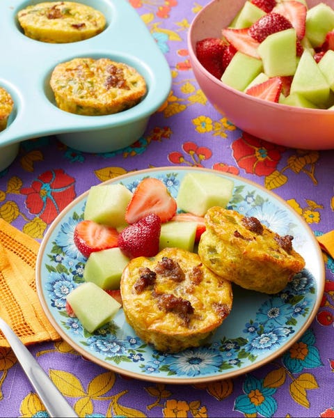individual sausage casseroles on plate with fruit salad