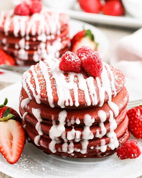 red velvet pancakes with white glaze and berries