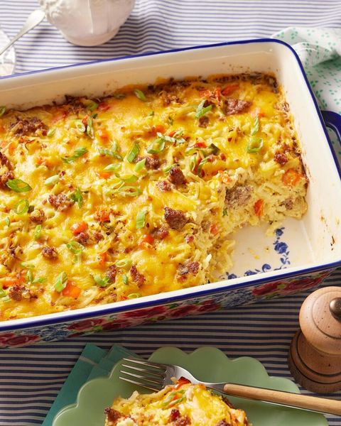 sausage breakfast casserole in floral dish with pepper grinder