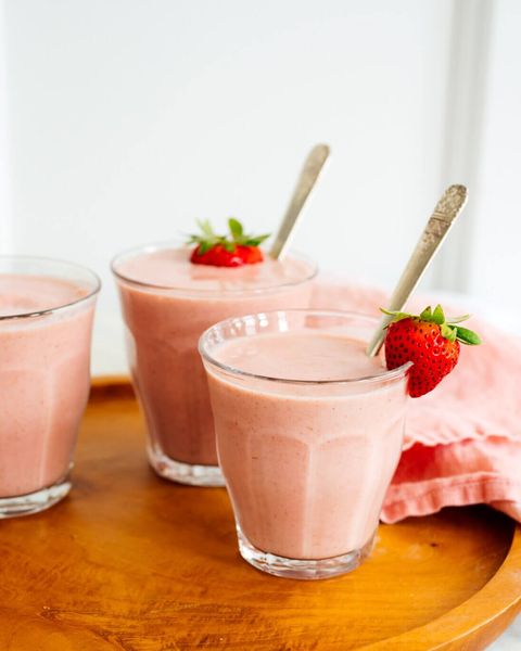 simple strawberry smoothie in glasses on wooden tray