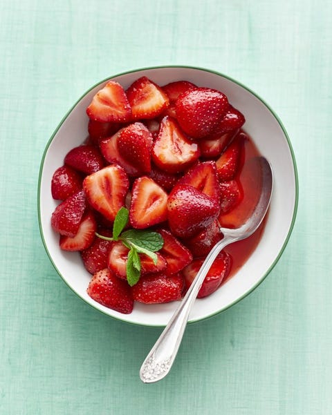 sweet strawberries on green background