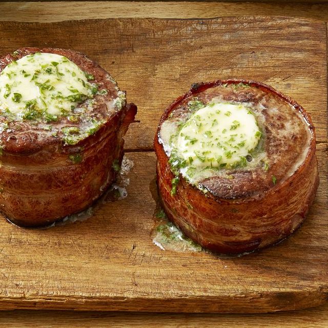 valentines day dinner ideas bacon wrapped filets on wood board with butter