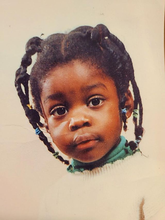 a stylized photo of writer vanessa bee as a young black girl with her hair in braids, looking into the camera