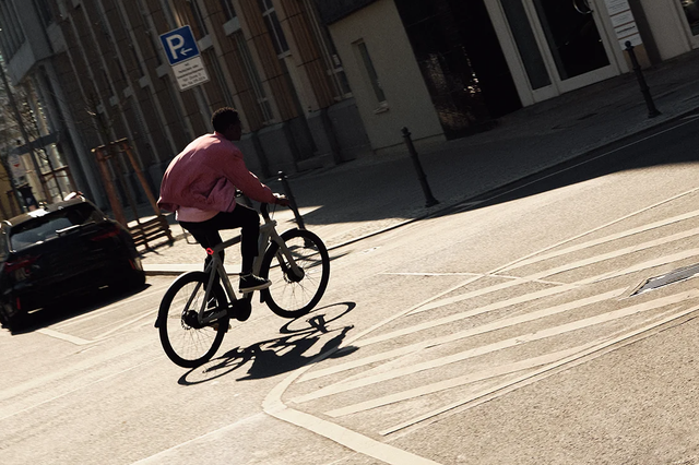 man riding e bike in city