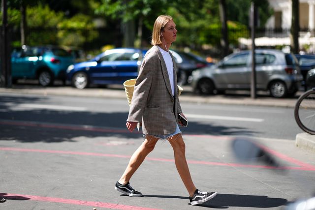 paris, france   july 03 a guest wears a white t shirt, a beige wickers bucket shoulder bag, blue denim ripped shorts, black sneakers from vans , outside the paco rabanne show, during paris fashion week, on july 03, 2022 in paris, france photo by edward berthelotgetty images