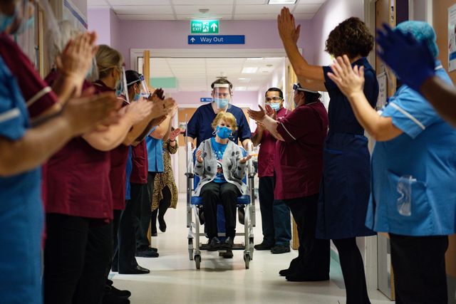 coventry, england   december 08 margaret keenan, 90, is applauded by staff as she returns to her ward after becoming the first person in the united kingdom to receive the pfizerbiontech covid 19 vaccine at university hospital at the start of the largest ever immunisation programme in the uk's history on december 8, 2020 in coventry, united kingdom more than 50 hospitals across england were designated as covid 19 vaccine hubs, the first stage of what will be a lengthy vaccination campaign nhs staff, over 80s, and care home residents will be among the first to receive the pfizerbiontech vaccine, which recently received emergency approval from the country's health authorities photo by jacob king   pool  getty images