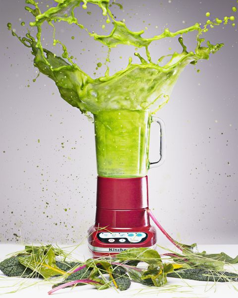 Vegetable juice splashing from blender