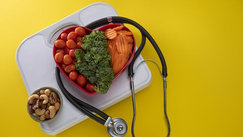 vegetables in a heart bowl with yellow background