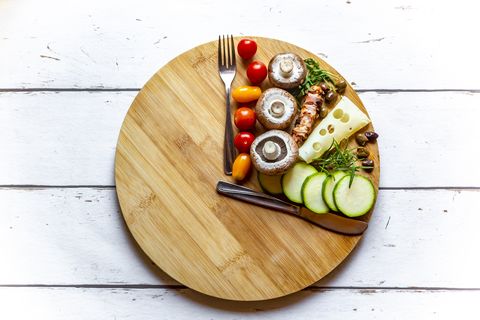 Vegetables on round chopping board, symbol for intermittent fasting