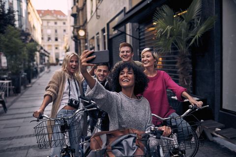 Friends Riding Bicycles In A City