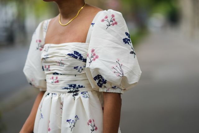 paris, france   may 02 ellie delphine wears a gold necklace, a white with navy blue and pink flower pattern straight neck off shoulder puffy sleeves long self portrait dress, on may 02, 2021 in paris, france photo by edward berthelotgetty images