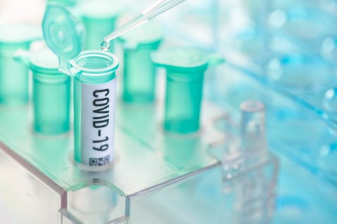 corona virus vial with pipette in laboratory