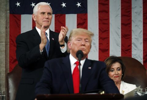 U.S. Vice President Mike Pence applauds as House Speaker Nancy Pelosi remains seated during U.S. President Donald Trump's