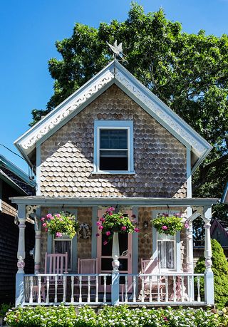 a victorian house with a porch and hanging plants on oak bluffs in marthas vineyard massachusetts