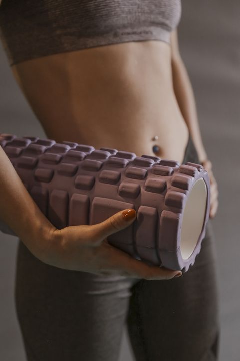 view of young woman holding a textured foam roller