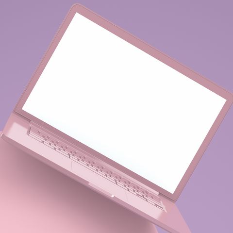 A computer and mobile phone against a pink background