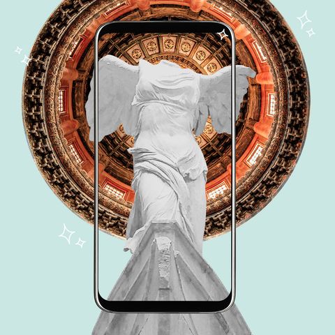 a phone with a statue on the screen