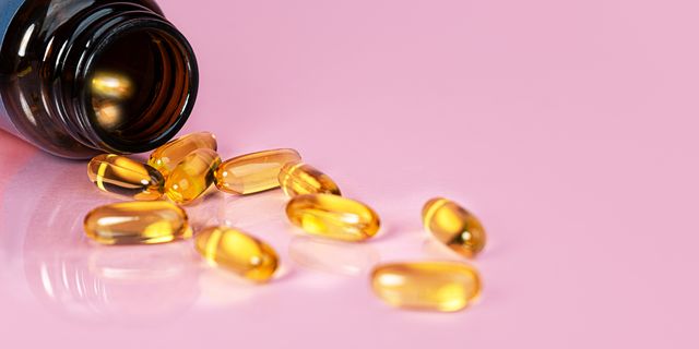 vitamin d bottle with capsules on yellow background omega 3