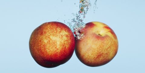 Close up of apples splashing in water