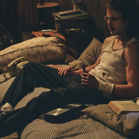 taylor kitsch stars as david koresh in waco he is seen, sitting down on a mattress and clutching a pen with a bloody wrist