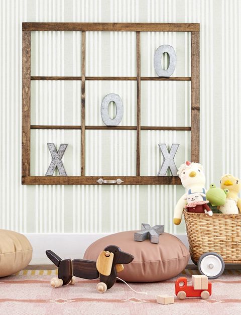 an old window with no glass becomes a tic tac toe game when hung on a wall