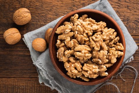 walnuts in bowl on wooden background