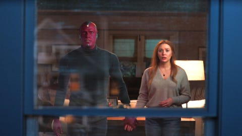 elizabeth olsen as wanda and paul bettany as vision looking out of a window in wandavision episode 9