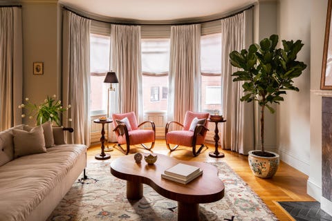 contemporary formal sitting room with pink arm chairs