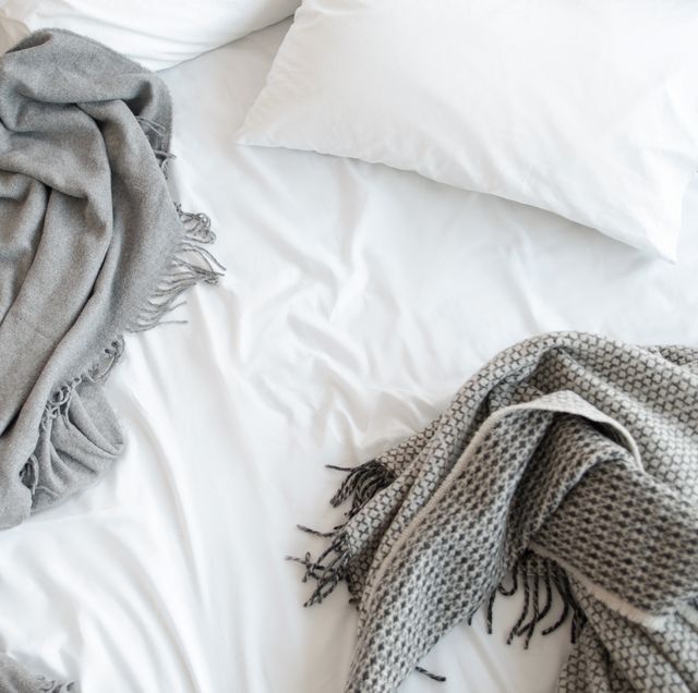 white sheets with grey throw blankets on bed