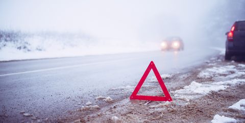 warning triangle placed on the roadway in winter conditions