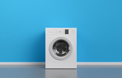 Washing machine at blue wall, frontal view with copy space,3d rendering (general design and captions)