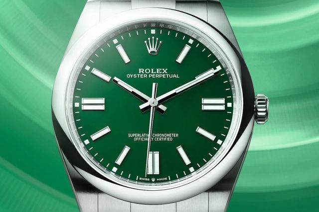 close up of a green rolex watch face with hands set to 10 past 10