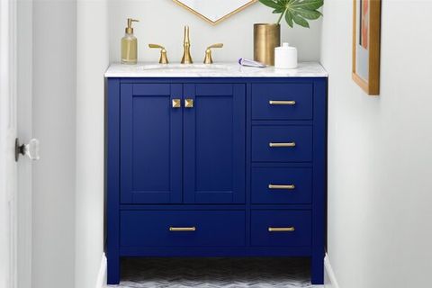 blue bathroom vanity with gold hardware and marble top