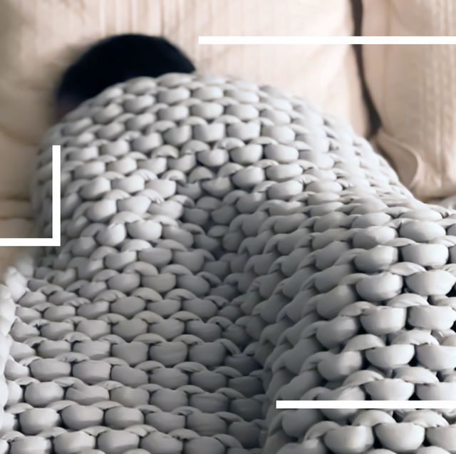person sleeping under weighted knit blanket