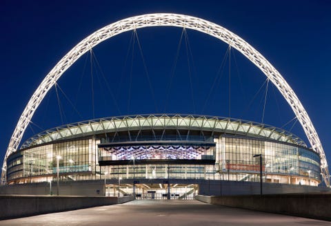 wembley stadium and statue of bobby moore at night