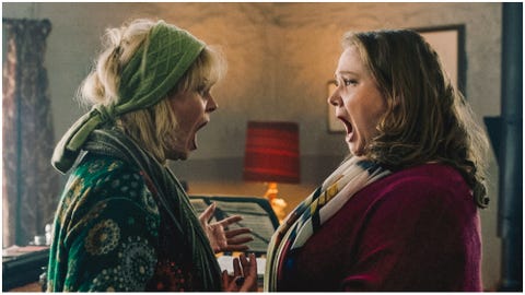 two women facing each other and singing