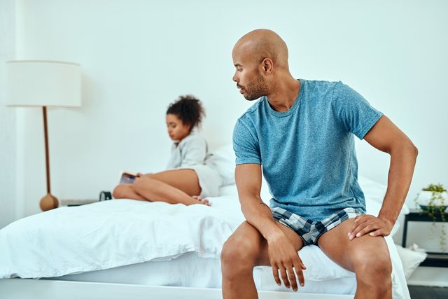 couple having a tense moment in bed