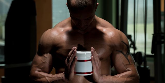 muscular handsome bodybuilder with pills and supplements beta alanine men's health