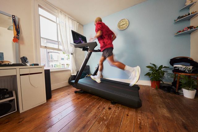 a person running on a treadmill in a house