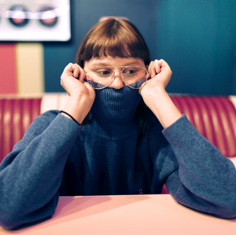 young woman sitting in a fast food great dof