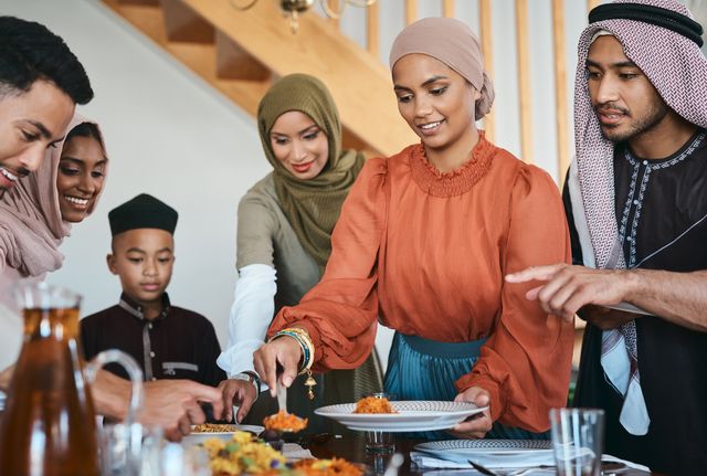 shot of a muslim family dishing lunch for themselves on eid al fitr