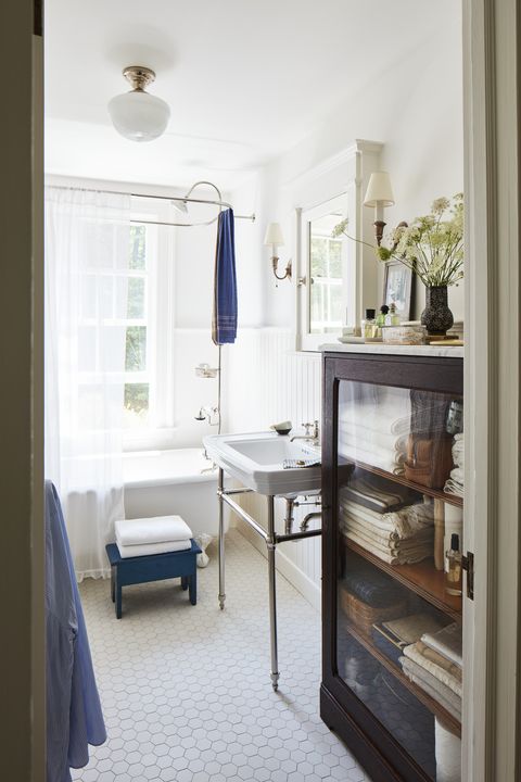 the master baths tub is from the early 20th century and the oak cabinet is antique