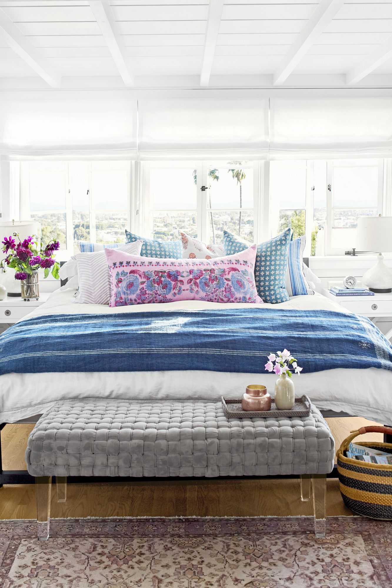 white bedding with colorful pillows