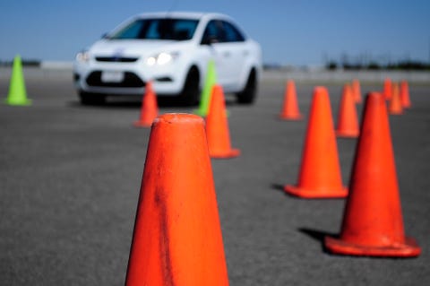 White Car and many traffic orange cones