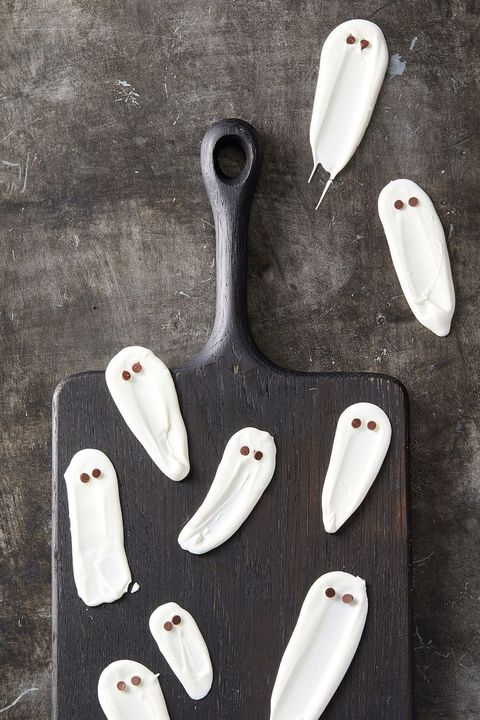 white chocolate ghosts on a black serving board