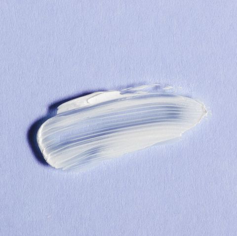 white skin cream smear on violet background
