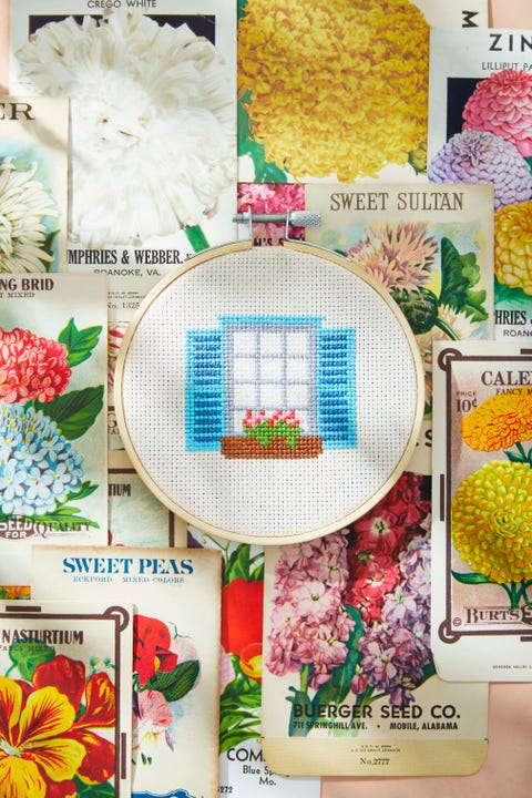 window box cross stitch on background of seed packets