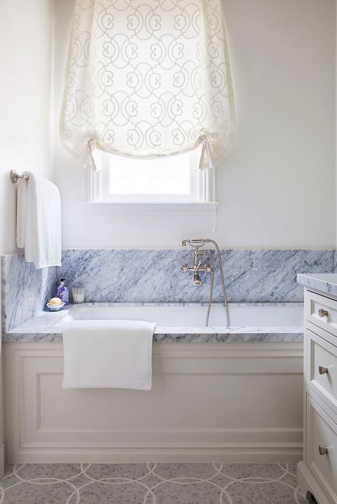 tub in bathroom with blue marble backsplash