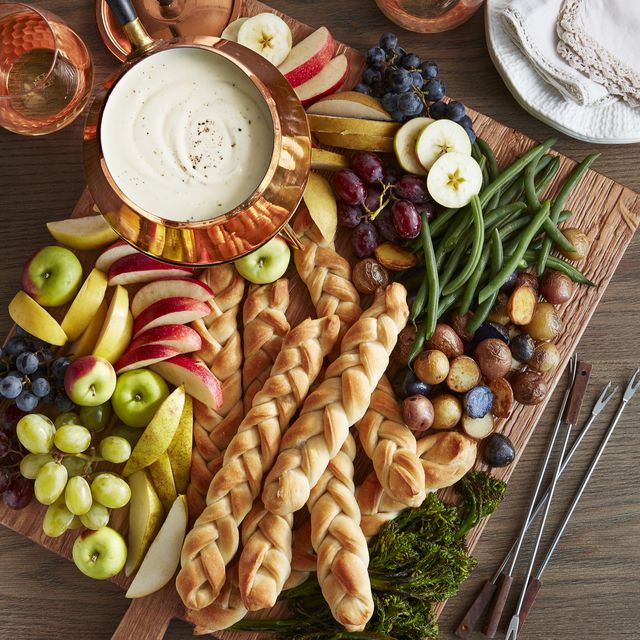 rustic cheese board with three cheese fondue and cable knit breadsticks