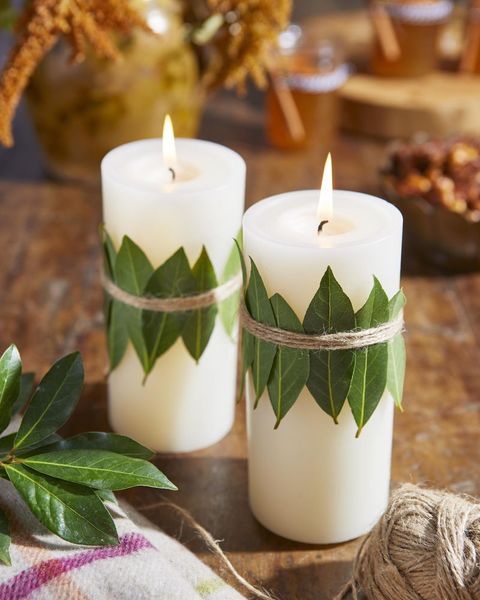 pillar candle with leaves tied around it